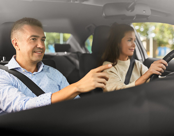 Driving instructor with teenager in car
