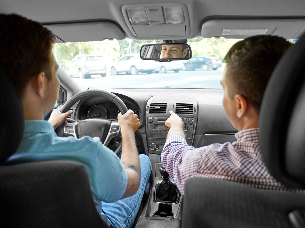 Male driving instructor with female student